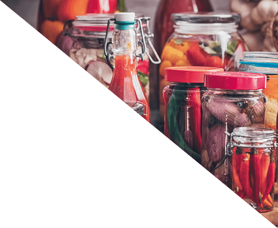 Preserving organic vegetables in jars like carrots, cucumbers, tomatoes, mushrooms, red onions and bok choy 