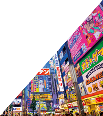 Tokyo, Japan - August 1, 2015: Crowds pass below colorful signs in Akihabara. The well known electronics district specializes in the sales of video games, anime, manga, and computer goods.