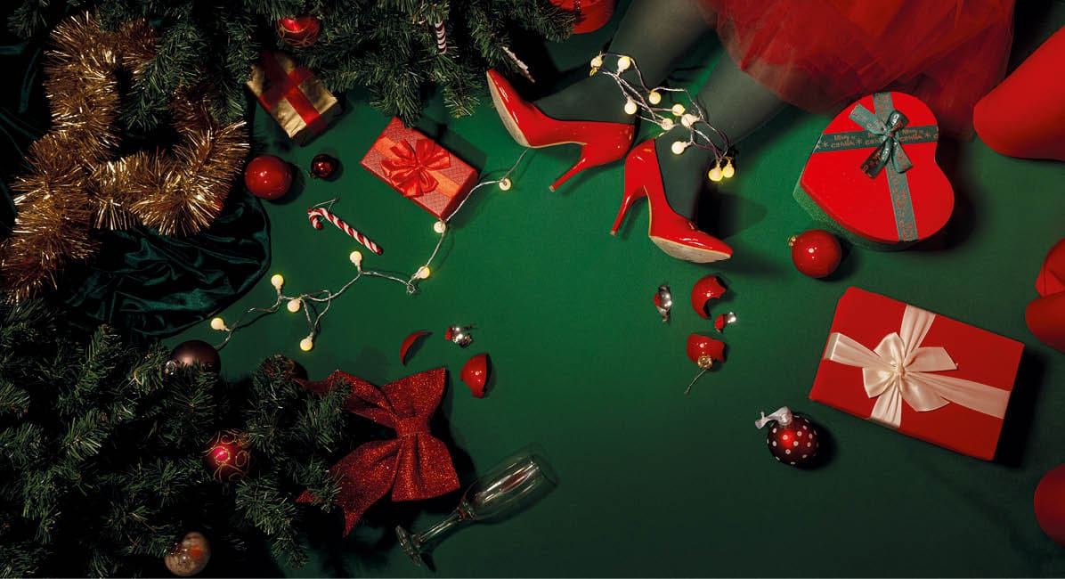 Christmas background with presents, Christmas tree and legs on green background with lights