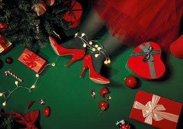 Christmas background with presents, Christmas tree and legs on green background with lights