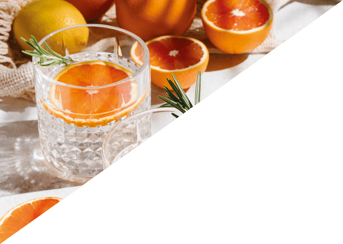 Summer orange cocktails with fresh citrus fruits. Hard seltzer, lemonade, refreshing drinks, low alcohol mocktails, summer party concept. Shadow and sunlight. Banner, flat lay, top view, copy space