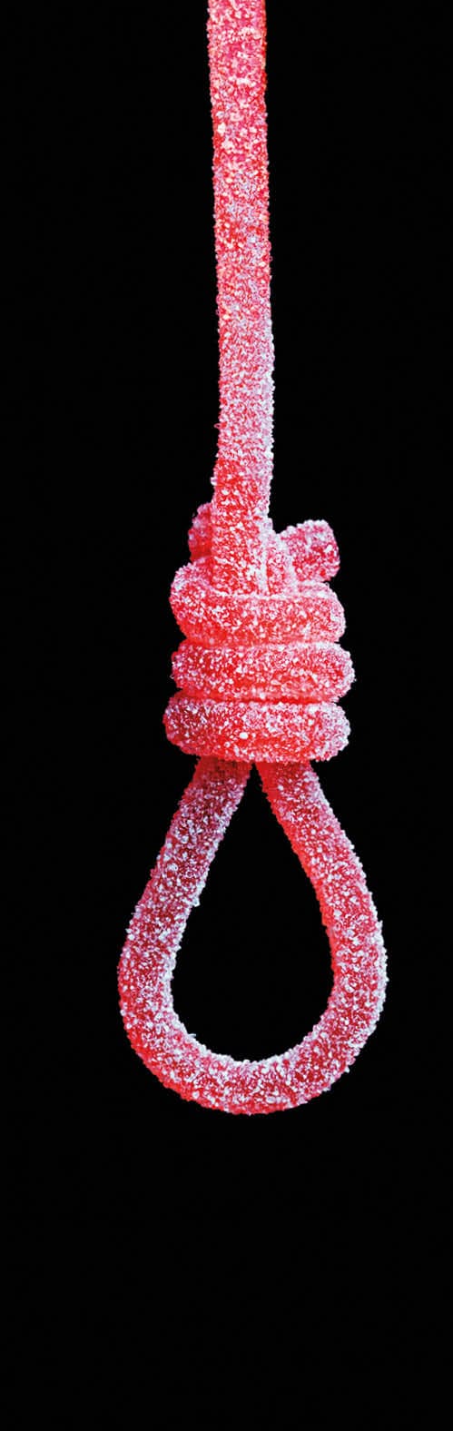 Candy string on a hanging knot representing unhealthy eating concept.